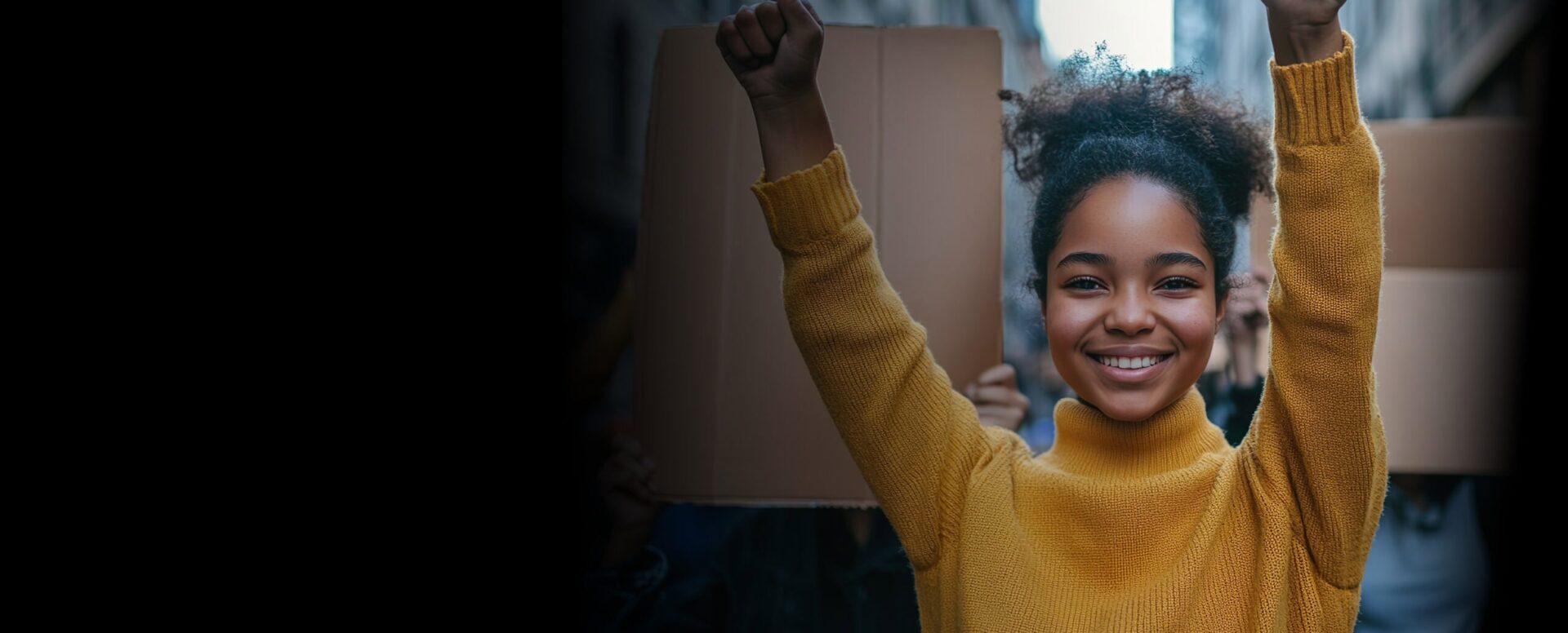 Young woman raising fist in a protest or rally.